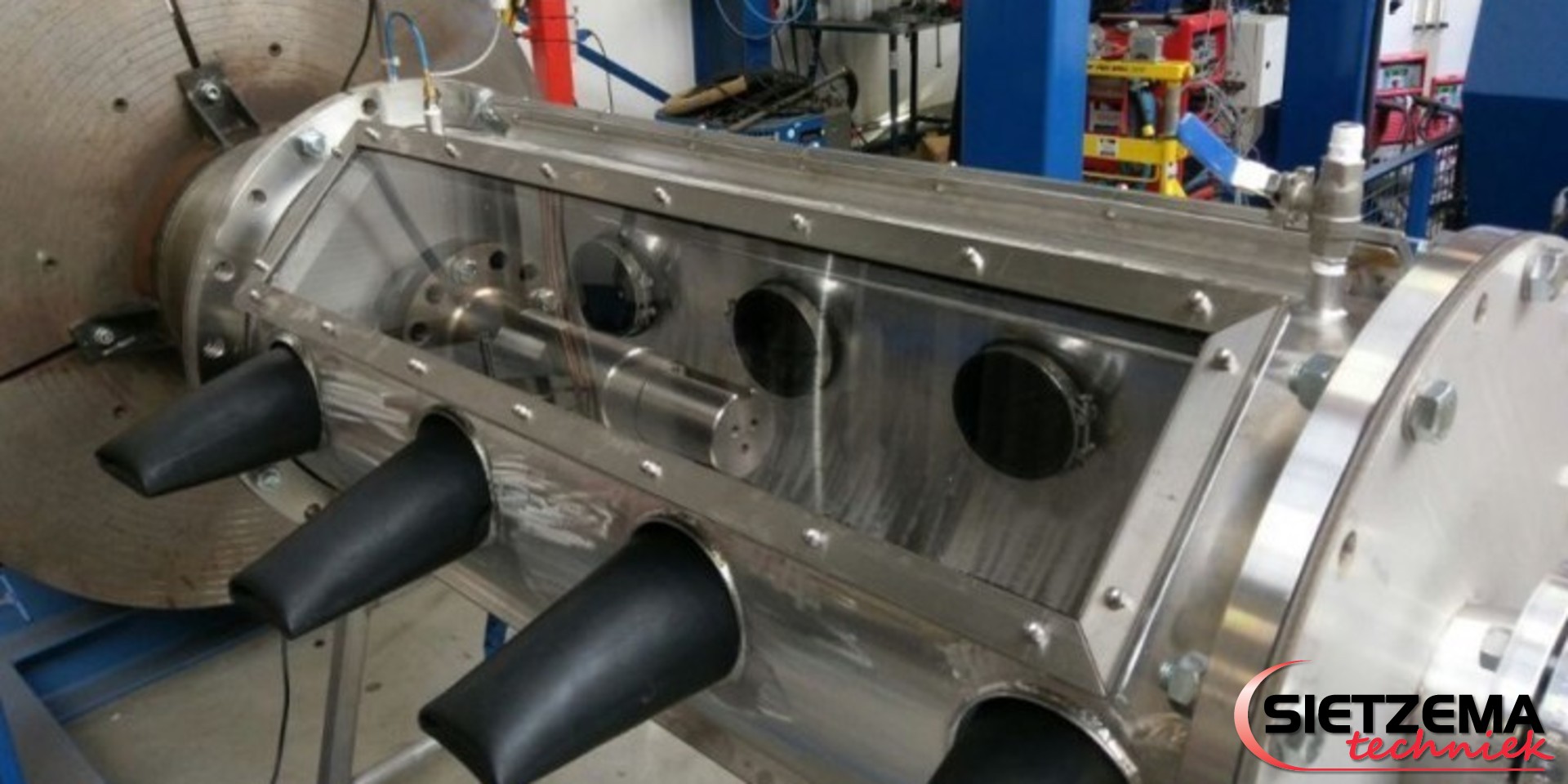 Vacuum cladding of titanium shaft in a welding enclosure